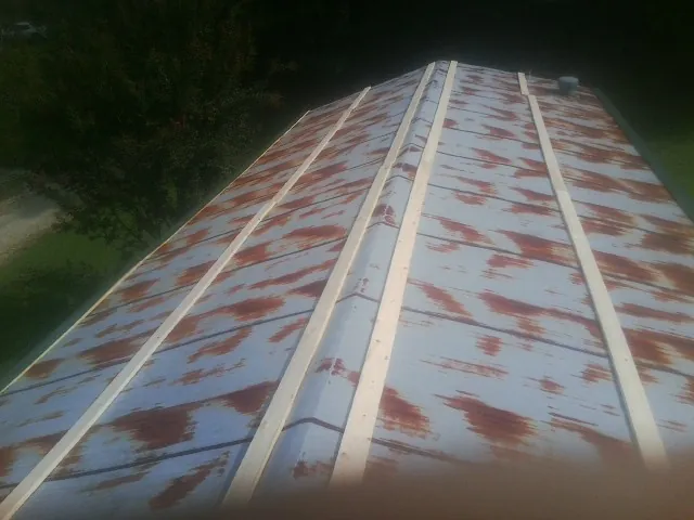 Rusted metal roof panels with new wood purlins before replacement — Storm Damage Roof Repair in Hogansville by Roofing Brothers