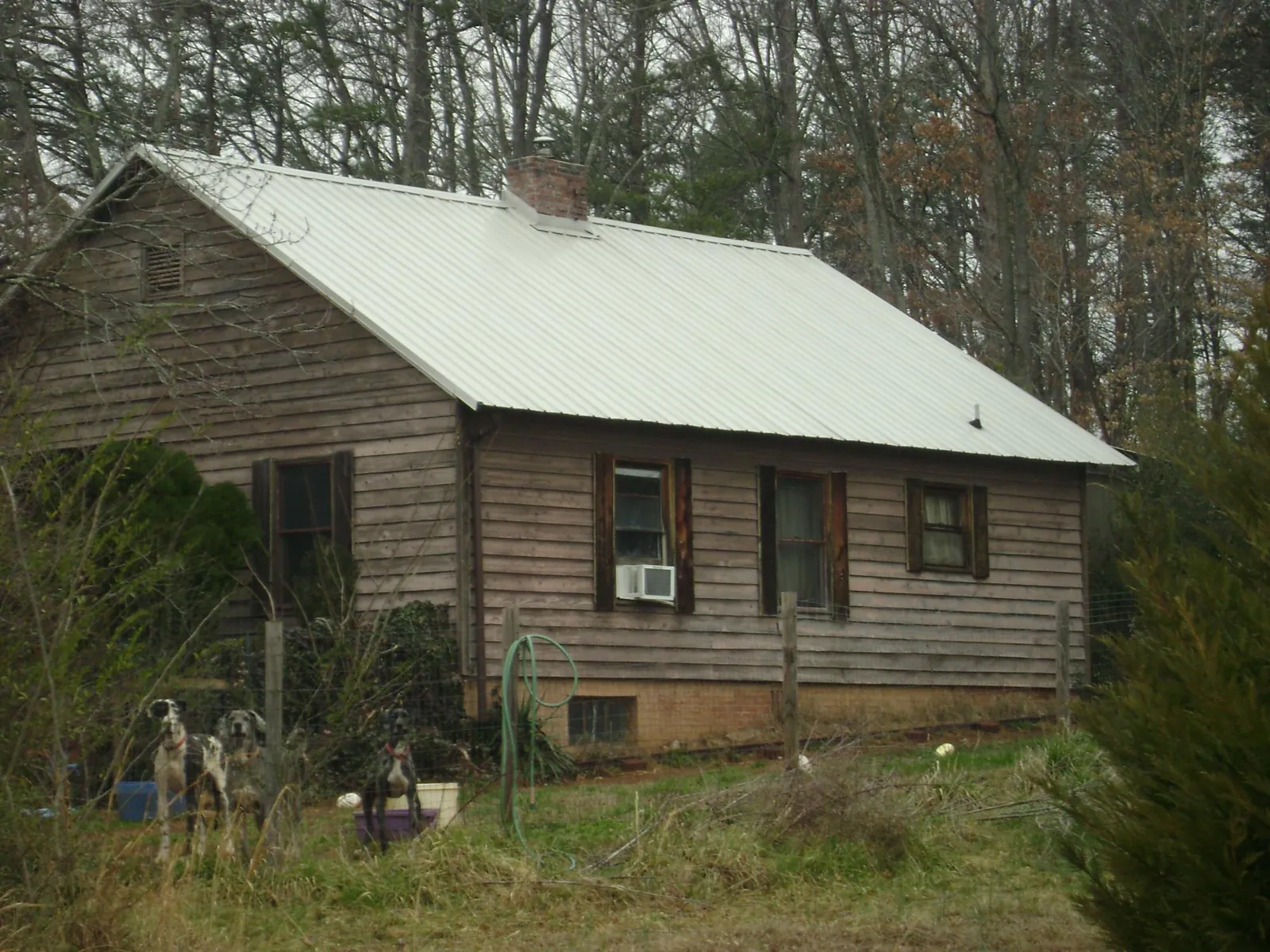 White metal roof on an old wood sided farmhouse, from a Metal Roof Installation job in Hogansville